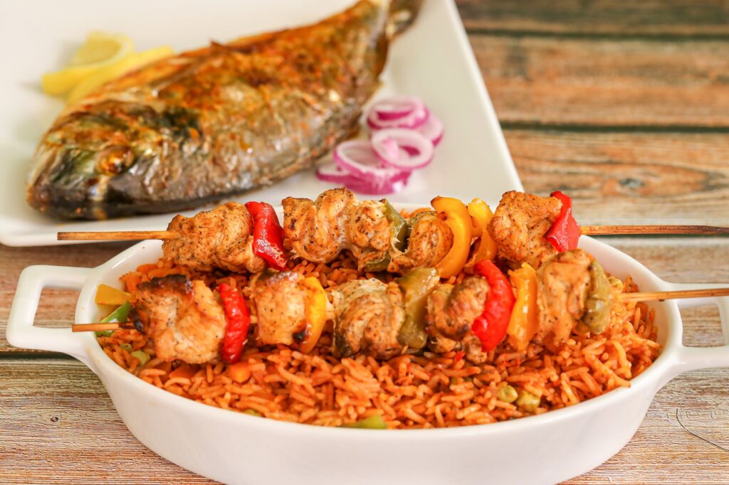 fish with jollof rice chicken and vegetables
