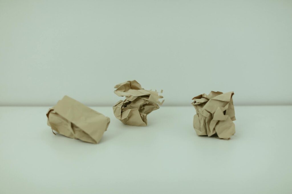 crumpled papers on white surface